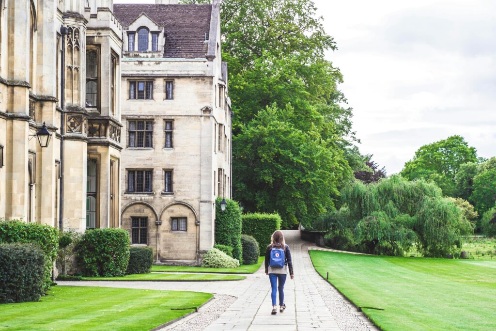 Picture of a female student walking down a path in a boarding school
