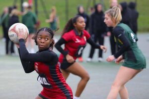 Female teens playing football