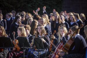 Boarding school students performing at a musical concert in school